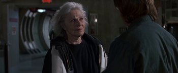 Movie still from “Stargate” (1994), directed by Roland Emmerich – An older woman with white hair talking to a man; Close Up shot, Over the shoulder angle