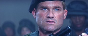 Movie still from “Stargate” (1994), directed by Roland Emmerich – A person wearing a hat and holding a gun; Close Up shot, Low angle