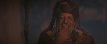 Movie still from “Stargate” (1994), directed by Roland Emmerich – An old man with a beard and a pirate hat; Close Up shot, Low angle