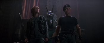 Movie still from “Stargate” (1994), directed by Roland Emmerich – A group of men standing next to each other; Medium shot, Low angle