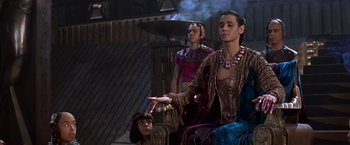 Movie still from “Stargate” (1994), directed by Roland Emmerich – A woman sitting on a chair next to another woman; Medium shot, Over the shoulder angle