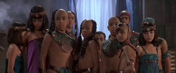 Movie still from “Stargate” (1994), directed by Roland Emmerich – A group of young men standing next to each other; Close Up shot, High angle