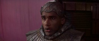 Movie still from “Stargate” (1994), directed by Roland Emmerich – A person wearing a helmet; Close Up shot, High angle