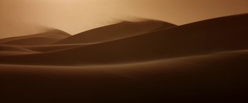 Movie still from “Stargate” (1994), directed by Roland Emmerich – A very large sand dune in the middle of a desert; Extreme Wide shot, High angle