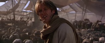 Movie still from “Stargate” (1994), directed by Roland Emmerich – A person wearing a scarf; Close Up shot, Low angle