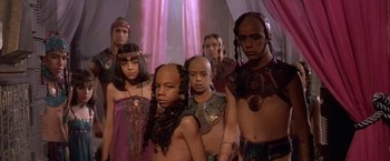 Movie still from “Stargate” (1994), directed by Roland Emmerich – A group of people standing next to each other; Medium shot, High angle