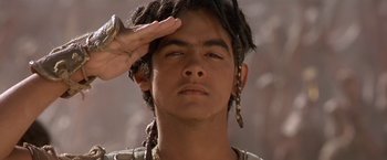 Movie still from “Stargate” (1994), directed by Roland Emmerich – A young man saluting with his right hand; Close Up shot, Low angle