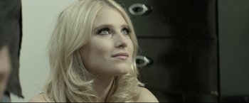 A beautiful blonde woman with long hair and green eyes looking up