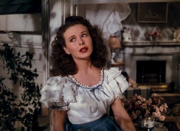 Movie still from “State Fair” (1945), directed by Walter Lang – A woman in a white blouse and blue skirt; Close Up shot, High angle