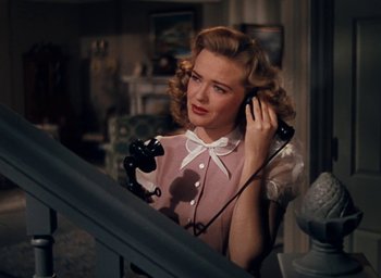 Movie still from “State Fair” (1945), directed by Walter Lang – A woman in a pink dress is holding a phone; Close Up shot, High angle