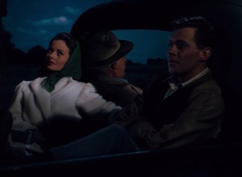 Movie still from “State Fair” (1945), directed by Walter Lang – A man and a woman sitting in the back of a car; Medium shot, High angle