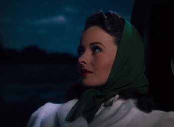 Movie still from “State Fair” (1945), directed by Walter Lang – A woman with a green head scarf sitting in a car; Close Up shot, Low angle