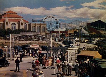 Movie still from “State Fair” (1945), directed by Walter Lang – An amusement park with a ferris wheel and a ferris wheel; Extreme Wide shot, High angle