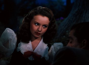 Movie still from “State Fair” (1945), directed by Walter Lang – A woman in a white blouse and a red bow tie; Close Up shot, Over the shoulder angle