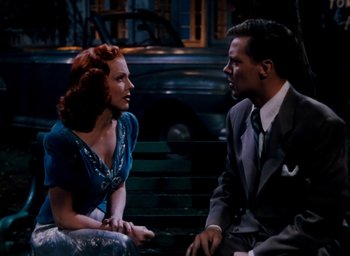 Movie still from “State Fair” (1945), directed by Walter Lang – A man and a woman sitting next to each other on a park bench; Medium shot, High angle