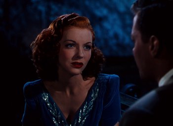 Movie still from “State Fair” (1945), directed by Walter Lang – A woman with red curly hair and a blue dress; Close Up shot, Over the shoulder angle
