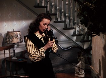 Movie still from “State Fair” (1945), directed by Walter Lang – A woman holding a phone up to her ear; Medium shot, High angle