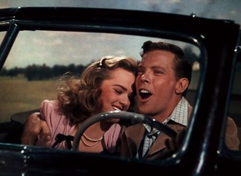Movie still from “State Fair” (1945), directed by Walter Lang – A man and a woman in the back seat of a car; Medium shot, Low angle