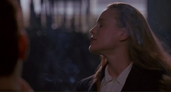 Movie still from “State of Grace” (1990), directed by Phil Joanou – A woman with her eyes closed and her mouth open; Close Up shot, Low angle