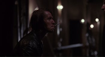 Movie still from “State of Grace” (1990), directed by Phil Joanou – A man smoking a cigarette while wearing a leather jacket; Close Up shot, Low angle