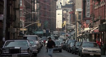 Movie still from “State of Grace” (1990), directed by Phil Joanou – A woman walking down a busy city street; Wide shot, Low angle
