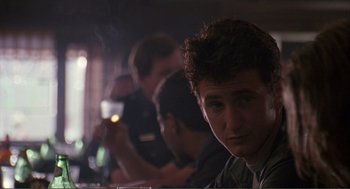 Movie still from “State of Grace” (1990), directed by Phil Joanou – A group of people sitting at a table; Close Up shot, Over the shoulder angle