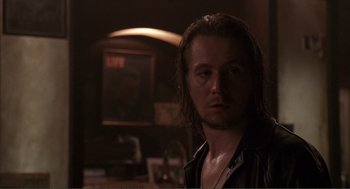 Movie still from “State of Grace” (1990), directed by Phil Joanou – A person with long brown hair; Close Up shot, Over the shoulder angle