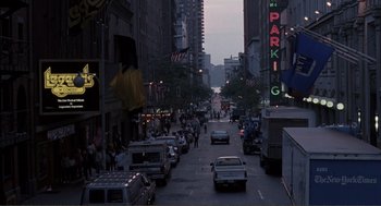 Movie still from “State of Grace” (1990), directed by Phil Joanou – A city street filled with lots of traffic at dusk; Extreme Wide shot, High angle
