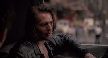 Movie still from “State of Grace” (1990), directed by Phil Joanou – A person with long hair; Close Up shot, Over the shoulder angle