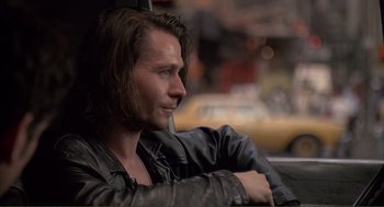 Movie still from “State of Grace” (1990), directed by Phil Joanou – A person sitting in a car; Close Up shot, Over the shoulder angle