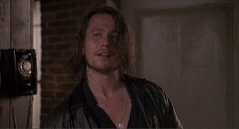 Movie still from “State of Grace” (1990), directed by Phil Joanou – A person with long hair; Close Up shot, Low angle