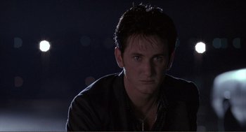 Movie still from “State of Grace” (1990), directed by Phil Joanou – A person wearing a black shirt; Close Up shot, Low angle