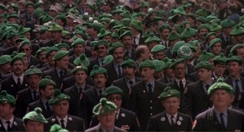 Movie still from “State of Grace” (1990), directed by Phil Joanou – A large group of men wearing green hats; Medium shot, High angle