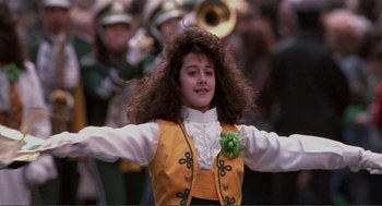Movie still from “State of Grace” (1990), directed by Phil Joanou – A young girl is dressed up and performing a dance; Medium shot, Low angle