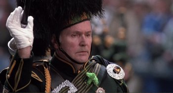 Movie still from “State of Grace” (1990), directed by Phil Joanou – A person wearing a uniform; Close Up shot, Low angle
