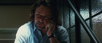 Movie still from “State of Play” (2009), directed by Kevin Macdonald – A person talking on a cell phone; Close Up shot, Low angle