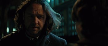 Movie still from “State of Play” (2009), directed by Kevin Macdonald – A person wearing a suit and tie; Close Up shot, Over the shoulder angle