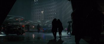 Movie still from “State of Play” (2009), directed by Kevin Macdonald – Two women are walking in the rain with an umbrella; Extreme Wide shot, High angle