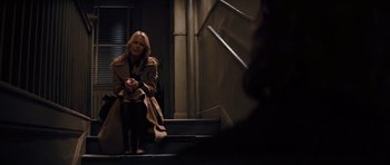 Movie still from “State of Play” (2009), directed by Kevin Macdonald – A woman sitting on the steps of a staircase; Wide shot, Over the shoulder angle