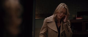 Movie still from “State of Play” (2009), directed by Kevin Macdonald – A woman in a tan coat walking down a street; Medium shot, Over the shoulder angle