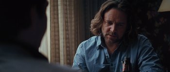 Movie still from “State of Play” (2009), directed by Kevin Macdonald – A person sitting at a table; Close Up shot, Over the shoulder angle