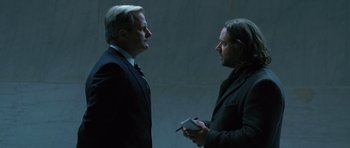 Movie still from “State of Play” (2009), directed by Kevin Macdonald – Two men in business suits talking to each other; Medium shot, Over the shoulder angle