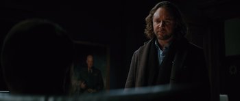 Movie still from “State of Play” (2009), directed by Kevin Macdonald – A man standing in front of a painting; Close Up shot, Over the shoulder angle