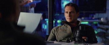 Movie still from “Stealth” (2005), directed by Rob Cohen – A man sitting at a table in front of a laptop; Close Up shot, Over the shoulder angle