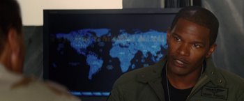 Movie still from “Stealth” (2005), directed by Rob Cohen – A man in front of a map of the world; Close Up shot, Over the shoulder angle