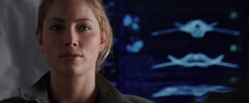 Movie still from “Stealth” (2005), directed by Rob Cohen – A woman's face in front of a wall; Close Up shot, Over the shoulder angle