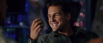 Movie still from “Stealth” (2005), directed by Rob Cohen – A man holding an apple in front of his face; Close Up shot, Over the shoulder angle