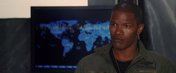 Movie still from “Stealth” (2005), directed by Rob Cohen – A man standing in front of a map of the world; Close Up shot, Over the shoulder angle