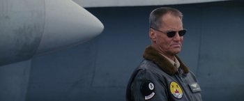 Movie still from “Stealth” (2005), directed by Rob Cohen – A man wearing a jacket and sunglasses standing next to an airplane; Close Up shot, Low angle