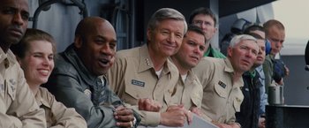 Movie still from “Stealth” (2005), directed by Rob Cohen – A group of men sitting next to each other; Medium shot, Low angle